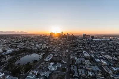 An aerial view of Los Angeles at dawn, with Westlake and MacArthur Park in the foreground and Downtown Los Angeles in the background.
