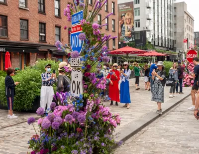 People gather on a street with no cars during the L.E.A.F. Festival of Flowers in the Meatpacking District of New York City.