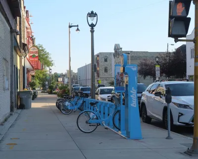Blue Bublr bikes parked at station on sidewalk in Milwaukee, Wisconsin.