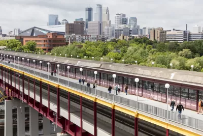 The Washington St Bridge in Minneapolis is shown with downtown Minneapolis in the background.