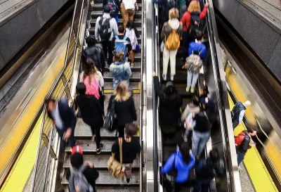 Blurred crowd on New York City subway escalator.