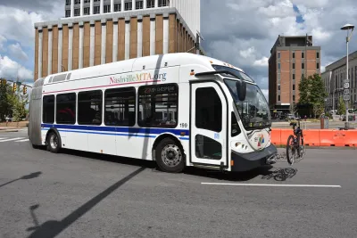 White public transit bus with bike on front bike rack in Nashville, Tennessee.