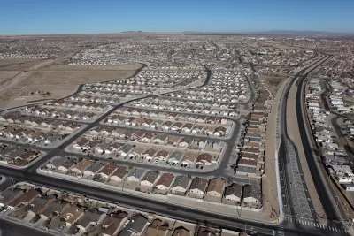 A spraling subdivision of single-family detached housing in a desert setting.