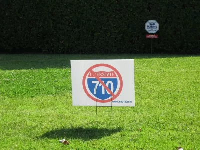 "No 710" lawn sign on green lawn.