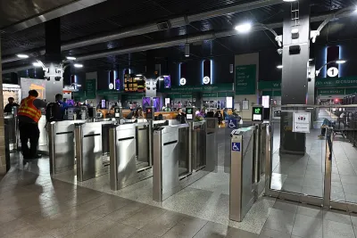 Silver fare collection gates at MBTA subway station.