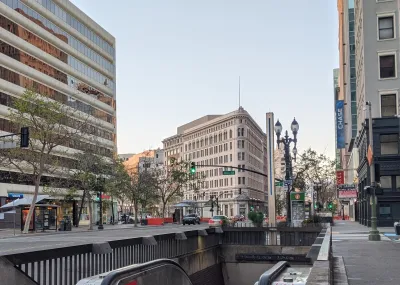 Street in Oakland, California with subway entrance in foreground.