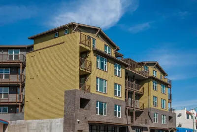 Four-story greenish-brown apartment buildings in Oakland, California.