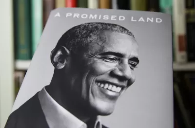 An image of the book "A Promised Land," by Barack Obama shows a black and white photo of the former president smiling.