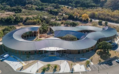 Aerial view of Ohana mental health facility in Monterey, California with wavy silver roof.