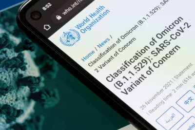 An image showing a smart phone with information from the World Health Organization about the Omicron variant of the coronavirus.