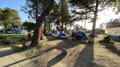 This is a panoramic photograph taken on April 1st, 2021, of People's Park in Berkeley, California. During the COVID-19 pandemic the authorities eased restrictions on overnight camping by homeless persons on the grounds of People's Park. The photograph shows the presence of some of the tents set up during this period.