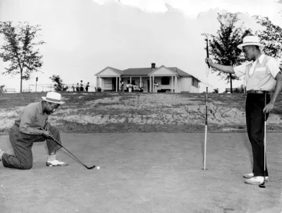 Black and white photo of two Black men playing golf at Langston golf course in Washington, D.C.