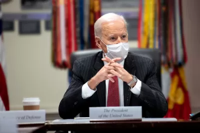 An image of President Joe Biden at a meeting in the White House while wearing a mask in February 2021.