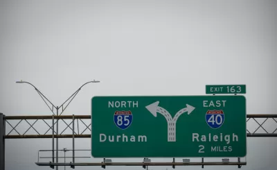 A freeway sign for an intersection showing Interstate 85 for Durham on the left and Interstate 40 for Raleigh on the right.