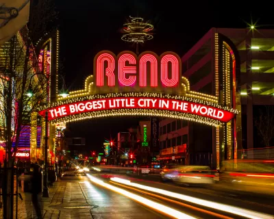 The famous (newer) "Biggest Little City in the World" sign in Reno, Nevada, with blurred lights from passing cars.