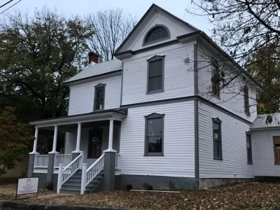 Restored white two-story historic home with black trim in Roanoke, Virginia