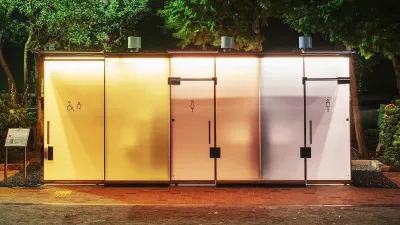 Public restroom with metal doors at night in Tokyo's Shibuya Ward.