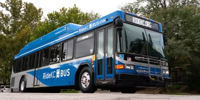 Blue RideKC bus in Kansas City with trees in background