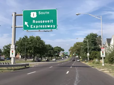 View of three-lane Roosevelt Boulevard with green Roosevelt Expressway road sign in Philadelphia, Pennsylvania.