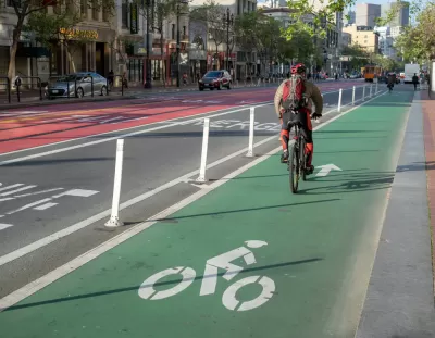 A cyclist commutes along a painted bike lan on Market Street in San Francisco.