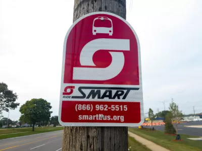 A sign for SMART Bus on a pole.