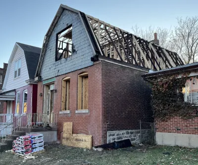 Brick two-story home with barn-shape roof under construction in St. Louis, Missouri.