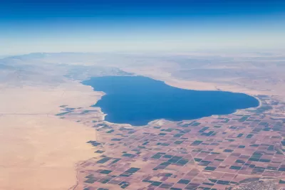 The land locked Salton Sea, seen from the air, is surrounded by mountains, desert, and farm land.