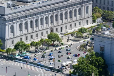 A group of socially distanced tents for the homeless are set up on a parking lot in San Francisco's Civic Center.