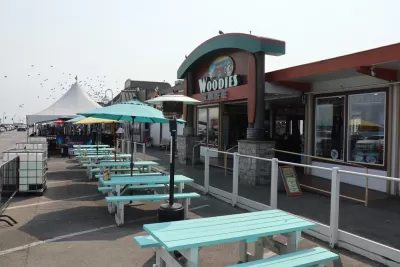 The former parking of Woodies restaurant is filled with empty picnic tables for dining during the Covid-19 pandemic.