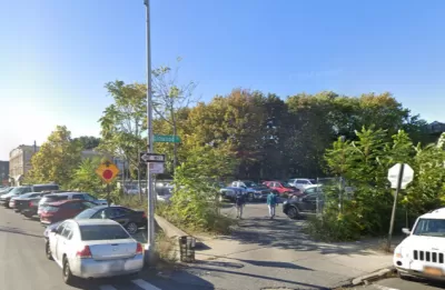 Google street view of vacant lot used for parking and surrounded by chain link fence and shrubbery in East New York