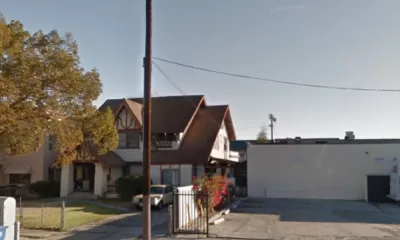Google street view of late Victorian home in Harvard Heights neighborhood of Los Angeles, with one-story commercial building next door.