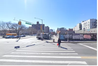 Google street view of New York City intersection with construction fence