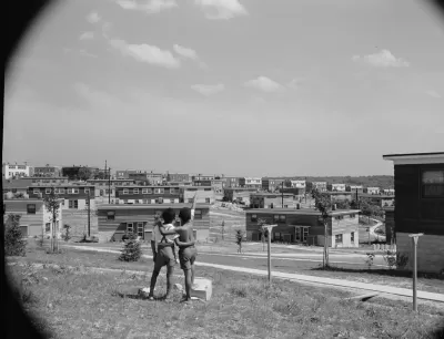 Black and white photo of two young boys standing on a hill overlooking the Frederick Douglass housing project in Anacostia, D.C.