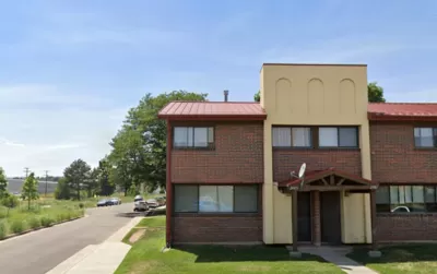 Google street view of two-story brick and stucco apartment building in Sun Valley neighborhood of Denver, Colorado.