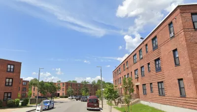 Google street view of brick three-story public housing buildings in Dorchester, MA.