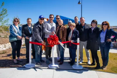 Officials cutting a ceremonial red ribbon at Skyline Ranch Park in Santa Clarita, California.