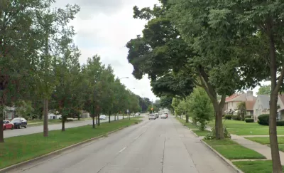 Street view of Sherman Blvd in Milwaukee, Wisconsin with landscaped median in middle of four-lane road.