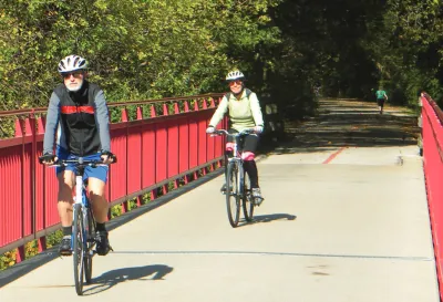 People riding bike son paved greenway in Indianapolis, Indiana.