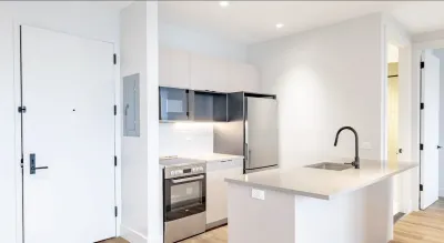Open plan kitchen interior of apartment in New York City without furniture or decor.