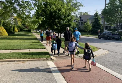 Children crossing a crosswalk paved with red bricks in Lakewood, Ohio.