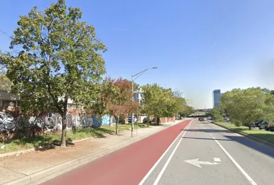 Red painted bus lane on street in Baltimore, Maryland.