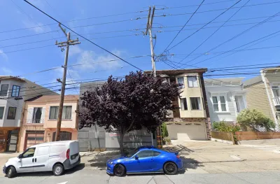Google street view of two-story residential building on San Francisco street covered in construction netting between other homes.