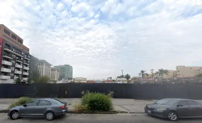 Google street view of vacant lot behind construction fence in Koreatown, Los Angeles, California.