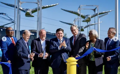 A group of politicians happily cut a blue ribbon.