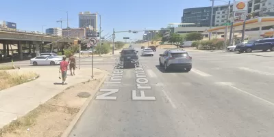 A concrete expanse is visible at the intersections of two wide roads in Austin, Texas.