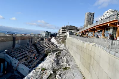Construction on a tunnel is visible next to the Seattle waterfront.