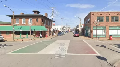 An intersection is adorned with paint depicting the Italian flag in St. Louis.