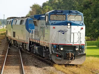 Amtrak Sunset Limited train passing by forested area in Cade, Louisiana