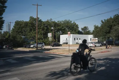 A bike rides by a church lot