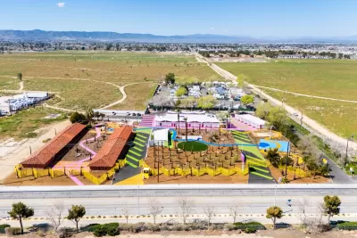 Aerial view of The Sierras, a colorful converted motel now serving as transitional housing in Lancaster, California.